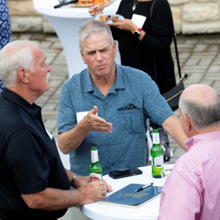 a group of men talking to each other