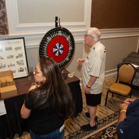 people standing in front of a dart board