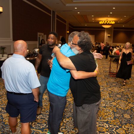 a group of people hugging in a room