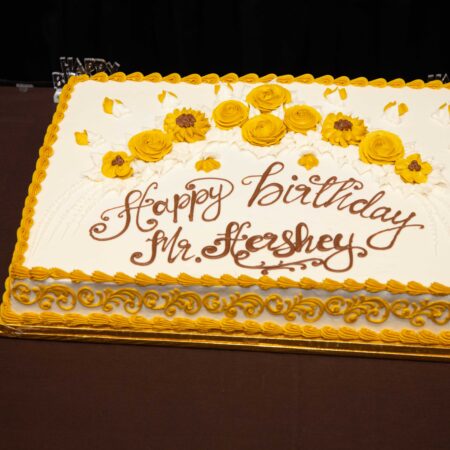 a cake with yellow frosting and sunflowers