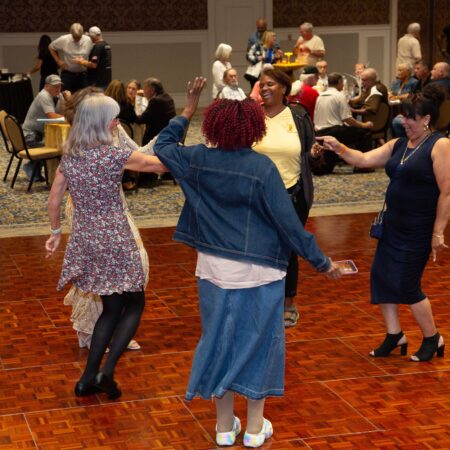 a group of women dancing in a room